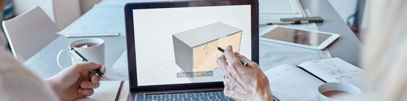 Architect, design engineer or contractor pointing to a 3d digital model on a laptop screen, discussing a plan or idea with a colleague in a meeting. Two business people talking about a work project.